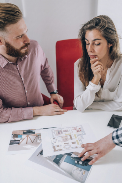 Real Estate Agency. Couple Looking at a Model of Their New Home